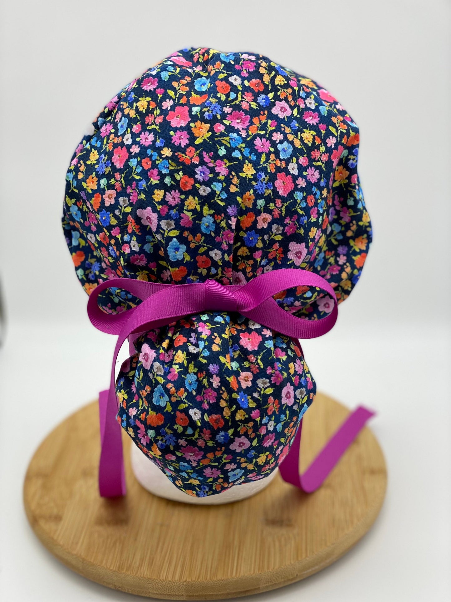 Pink and navy floral ponytail scrub cap