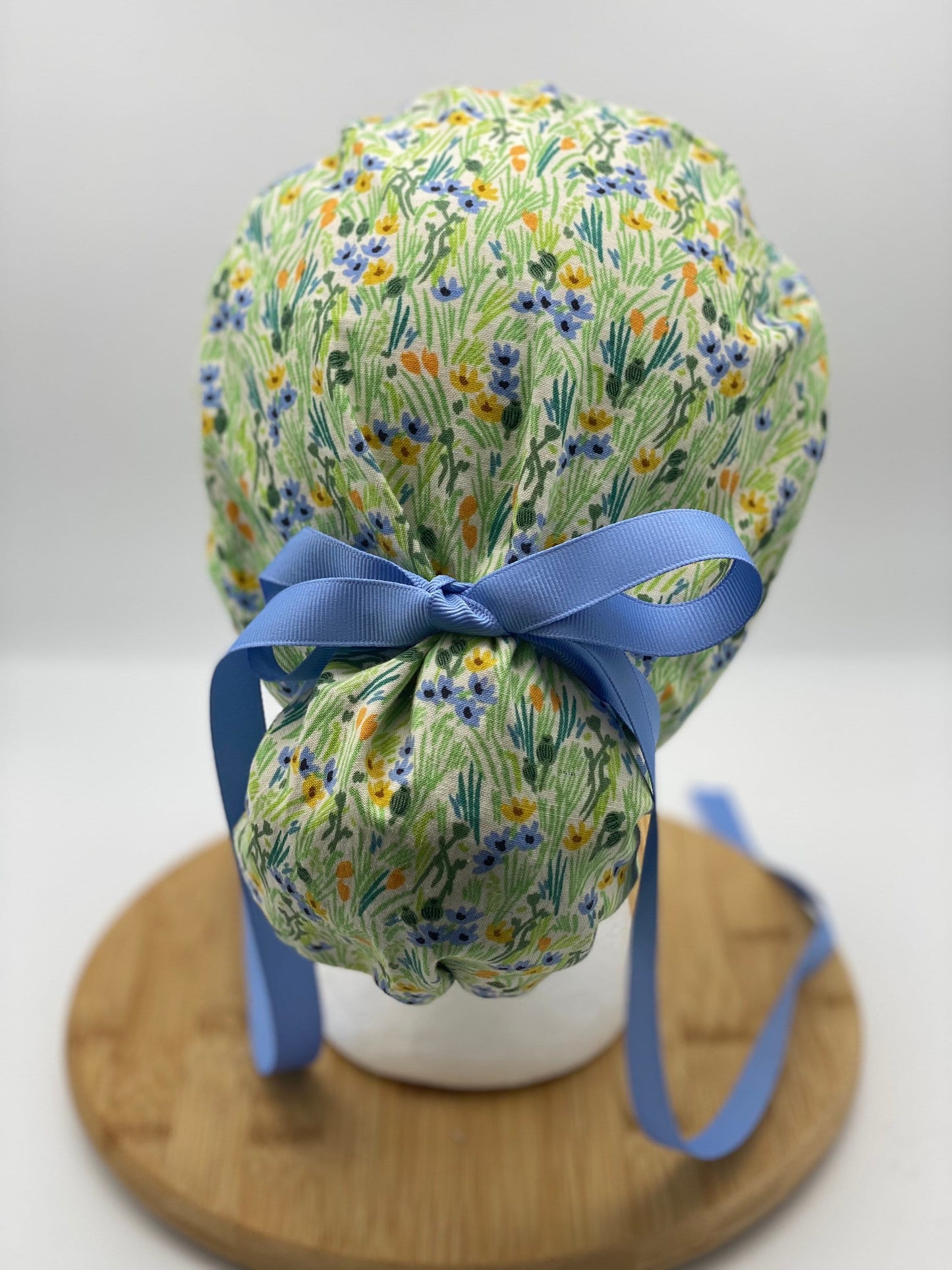 Green and blue floral ponytail scrub cap