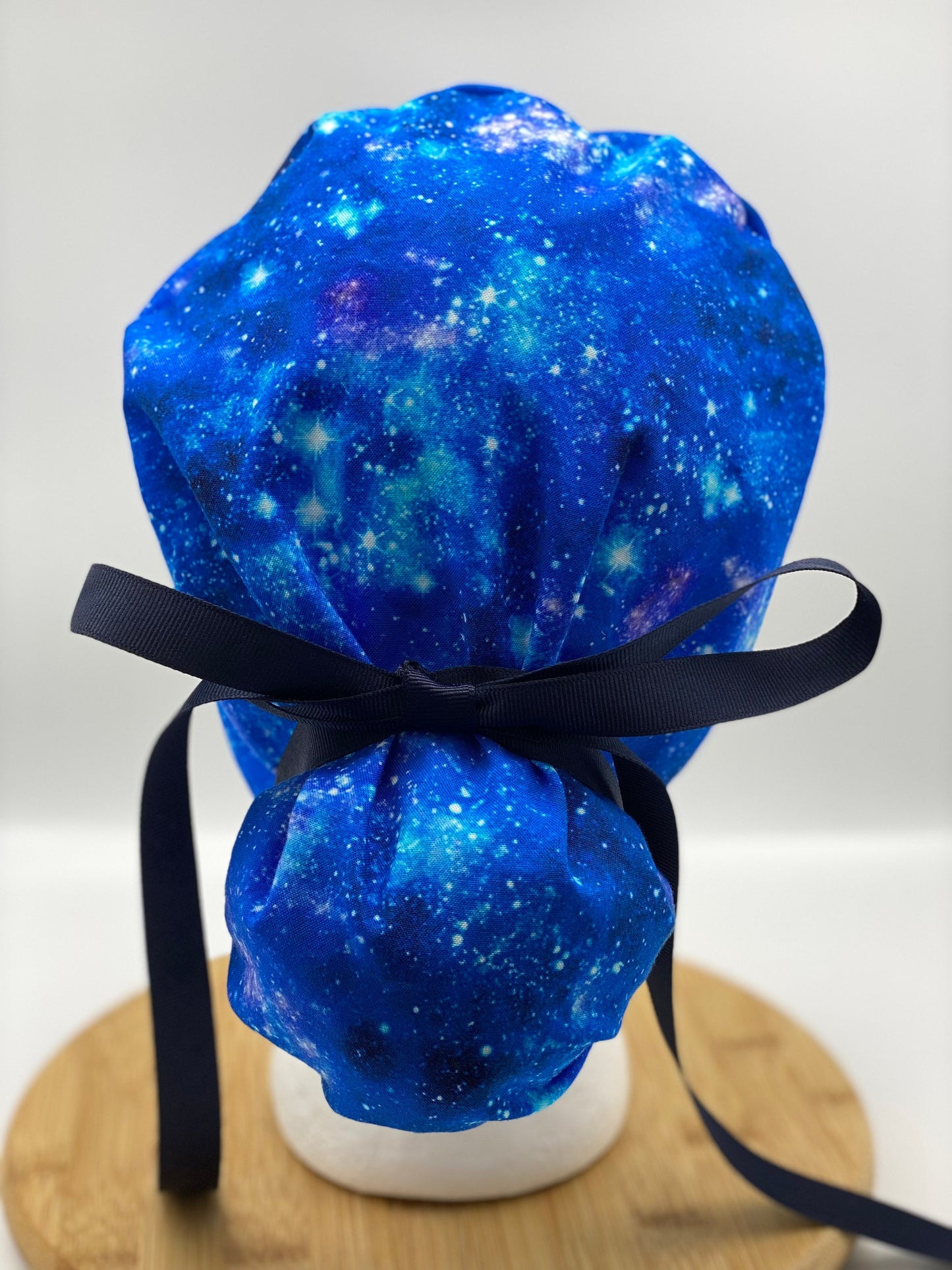 Blue galaxy print ponytail scrub hat